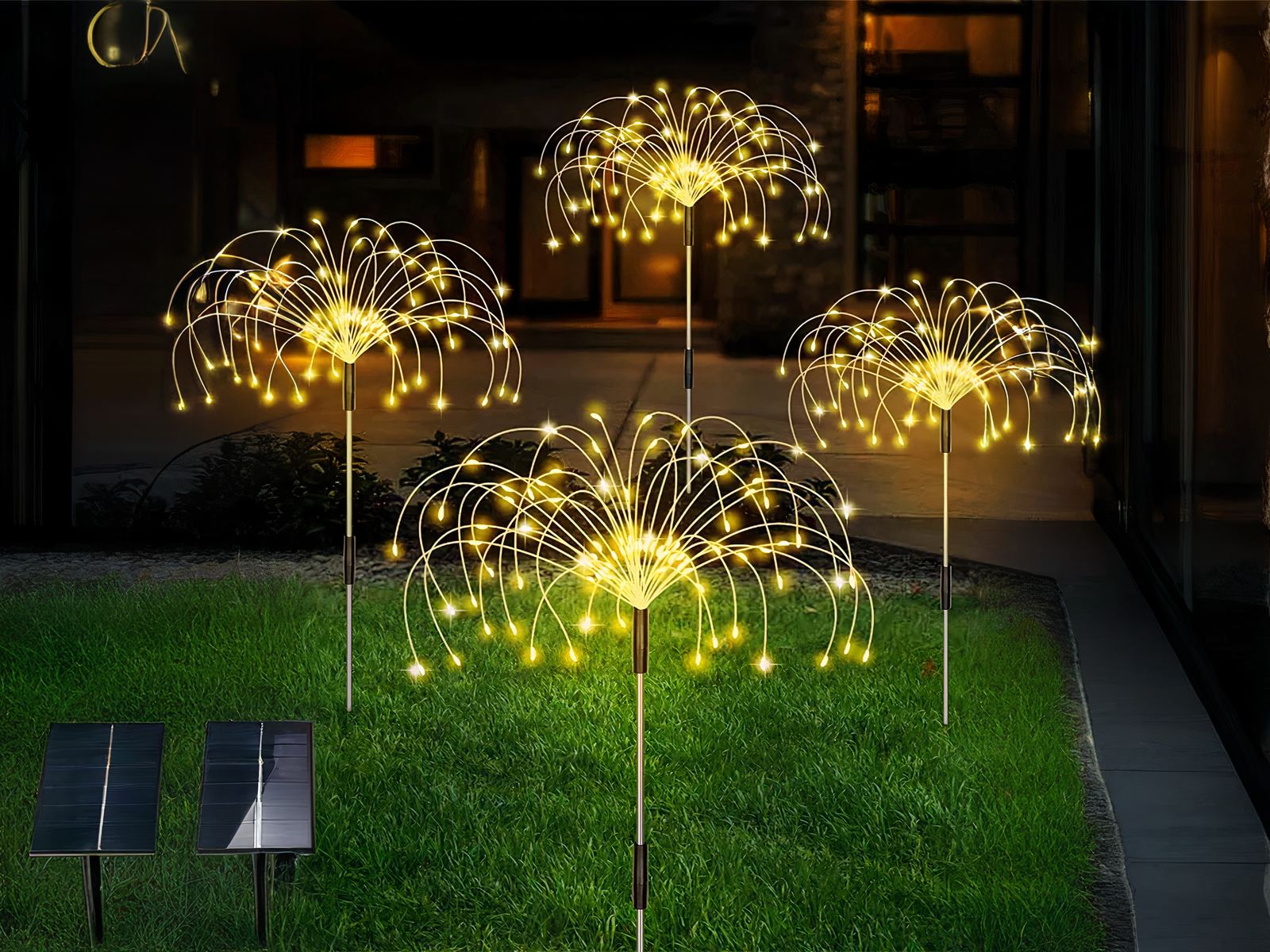 Lot de 4 Lampes LED solaires en forme de feux d'artifices, dans un jardin.