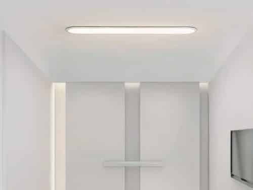 Panneau LED blanc design moderne et minimaliste, dans une pièce blanche.