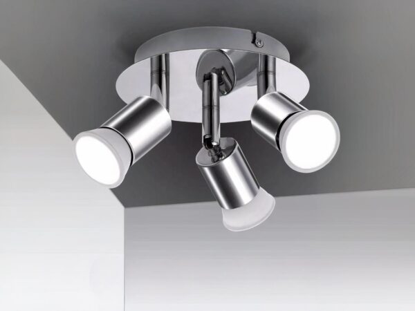 Projecteur LED argenté avec têtes rotatives installé sur un plafond gris