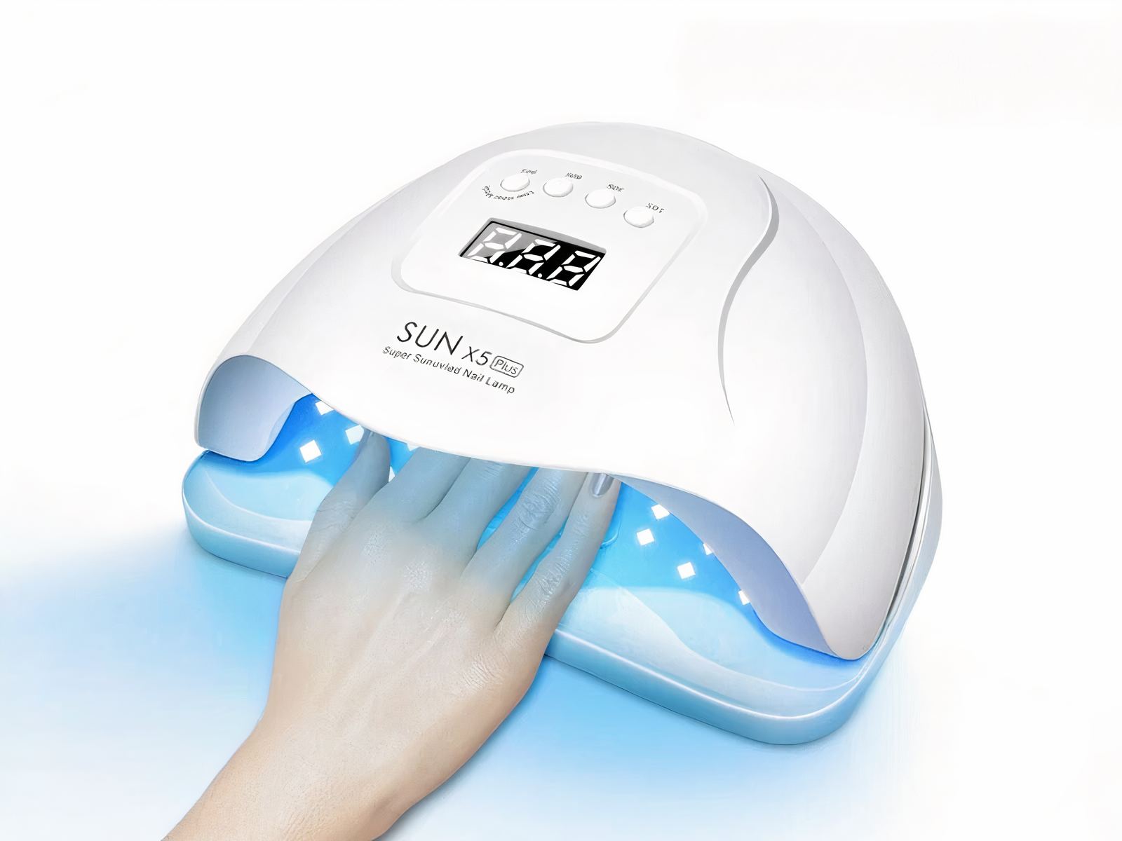 Lampe LED ongle UV tous types de vernis Lampe LED ongle UV, blanche, allumée, une femme y met la main.