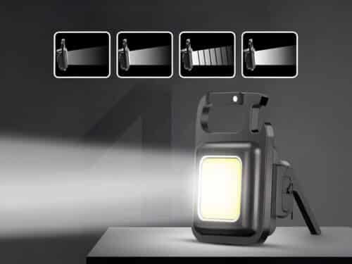 Mini lampe LED multifonctionnelle pour porte clés, sur un fond noir