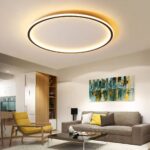 Plafonnier LED aluminium noir circulaire Plafonnier LED aluminium noir circulaire installé au plafond d'un salon avec un canapé gris et un fauteuil jaune, ainsi qu'une table basse carrée noire.