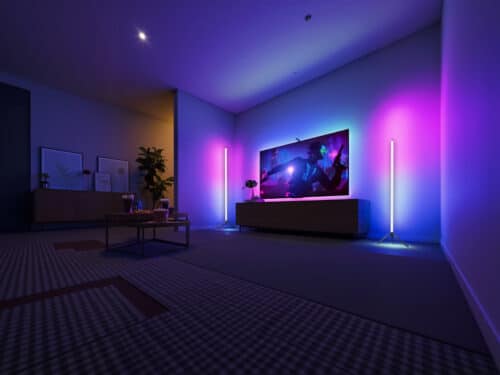 Lampadaire LED d’angle intelligent en forme de tube, sur pied, design minimaliste noir, lumière RGB personnalisable dans un salon moderne.