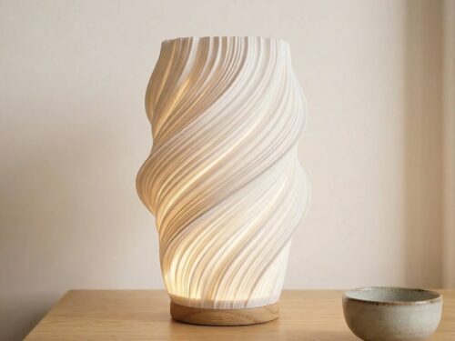 La lampe de table LED design contemporain avec forme ondulée moderne, lumière douce diffusée créant une ambiance apaisante, objet déco élégant posé sur une table intérieur en bois minimaliste.